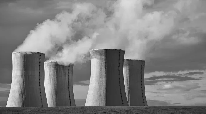 Four cooling towers of a power plant releasing steam